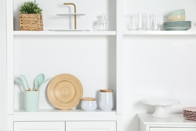 White shelving unit with different kitchenware indoors