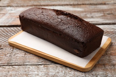 Photo of Tasty chocolate sponge cake on wooden table, closeup