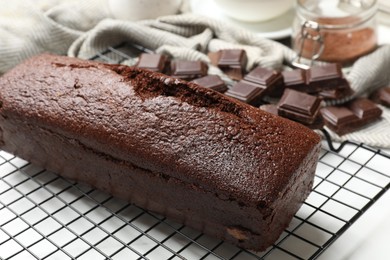 Photo of Tasty chocolate sponge cake on white table, closeup