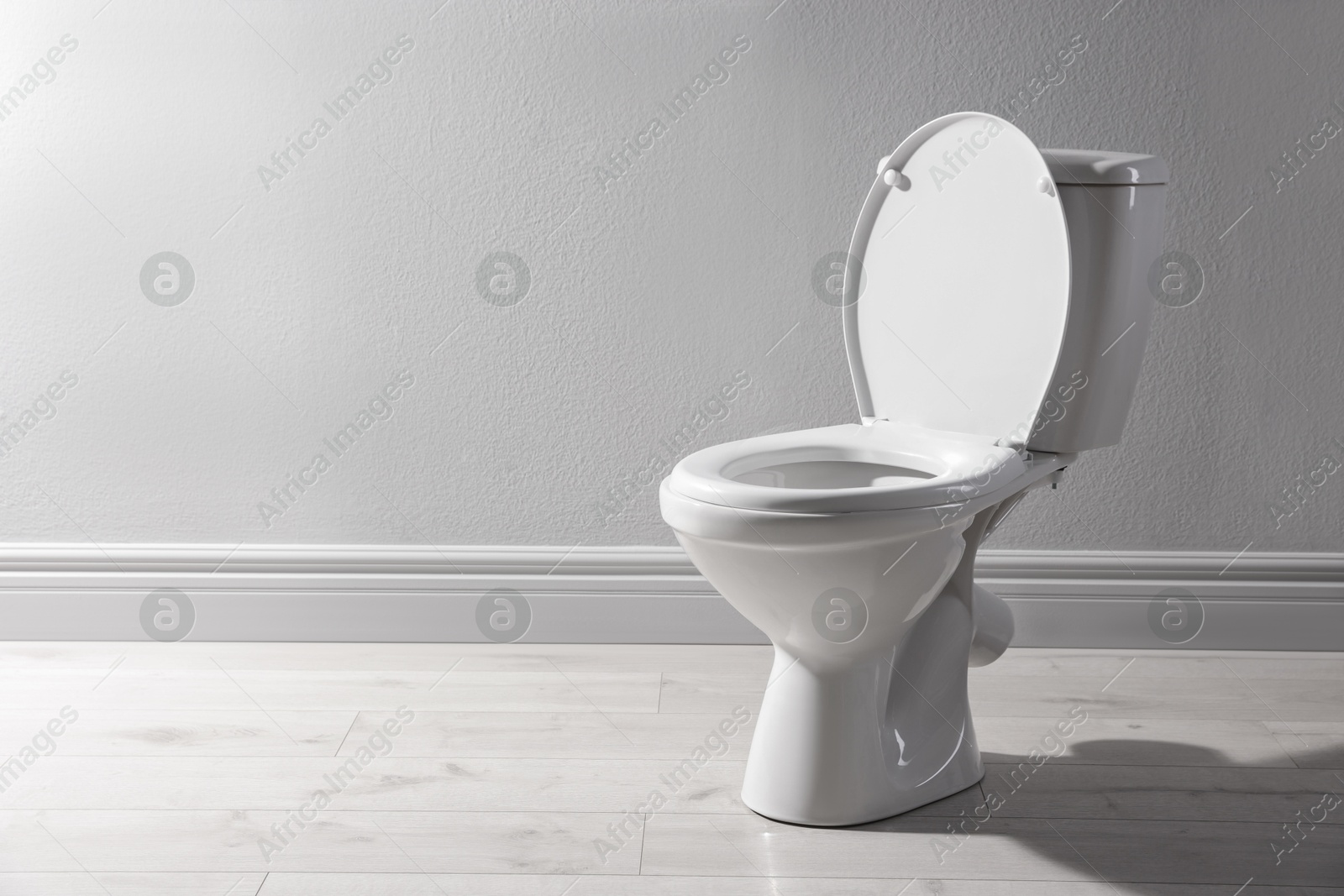 Photo of One toilet bowl near white wall indoors, space for text