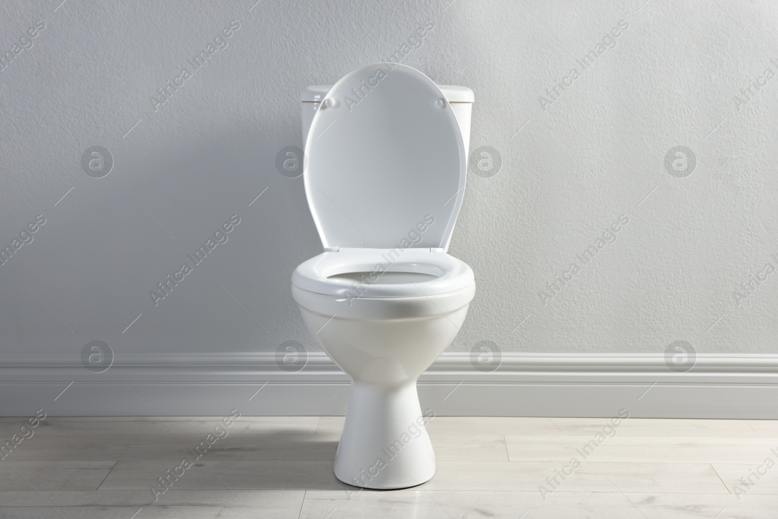 Photo of One toilet bowl near white wall indoors