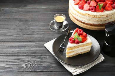 Photo of Tasty sponge cake with fresh berries and mint served on black wooden table, space for text