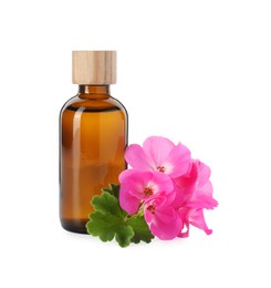 Photo of Geranium essential oil in bottle and beautiful flowers isolated on white