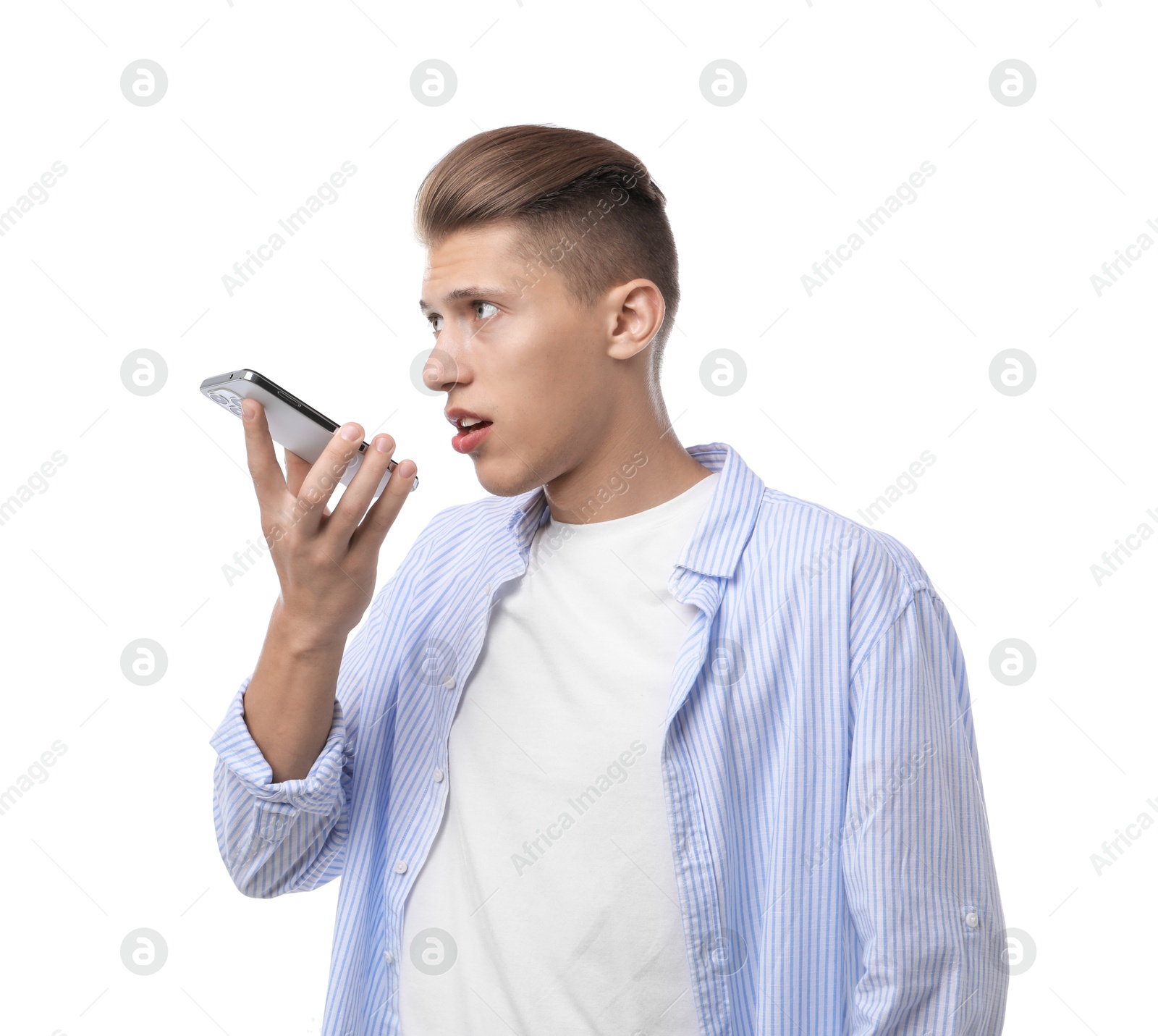 Photo of Young man recording voice message via smartphone on white background