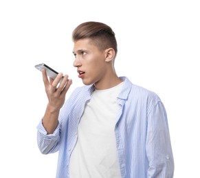 Photo of Young man recording voice message via smartphone on white background