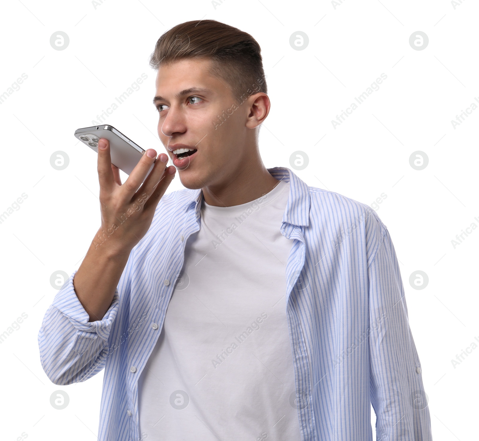 Photo of Young man recording voice message via smartphone on white background