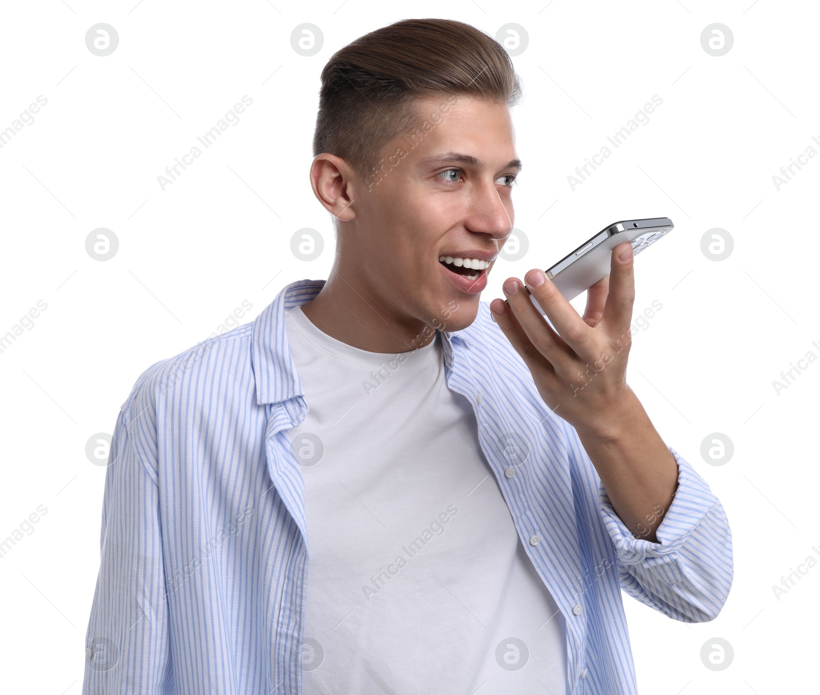 Photo of Young man recording voice message via smartphone on white background