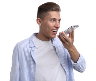 Photo of Young man recording voice message via smartphone on white background