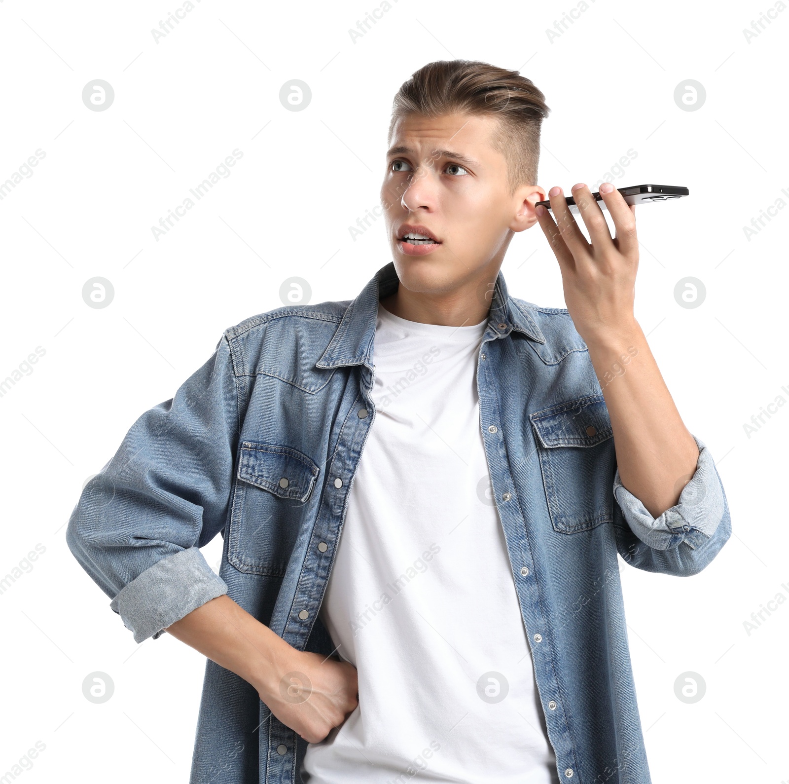 Photo of Young man with smartphone listening to voice message on white background