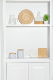 White shelving unit with different kitchenware indoors