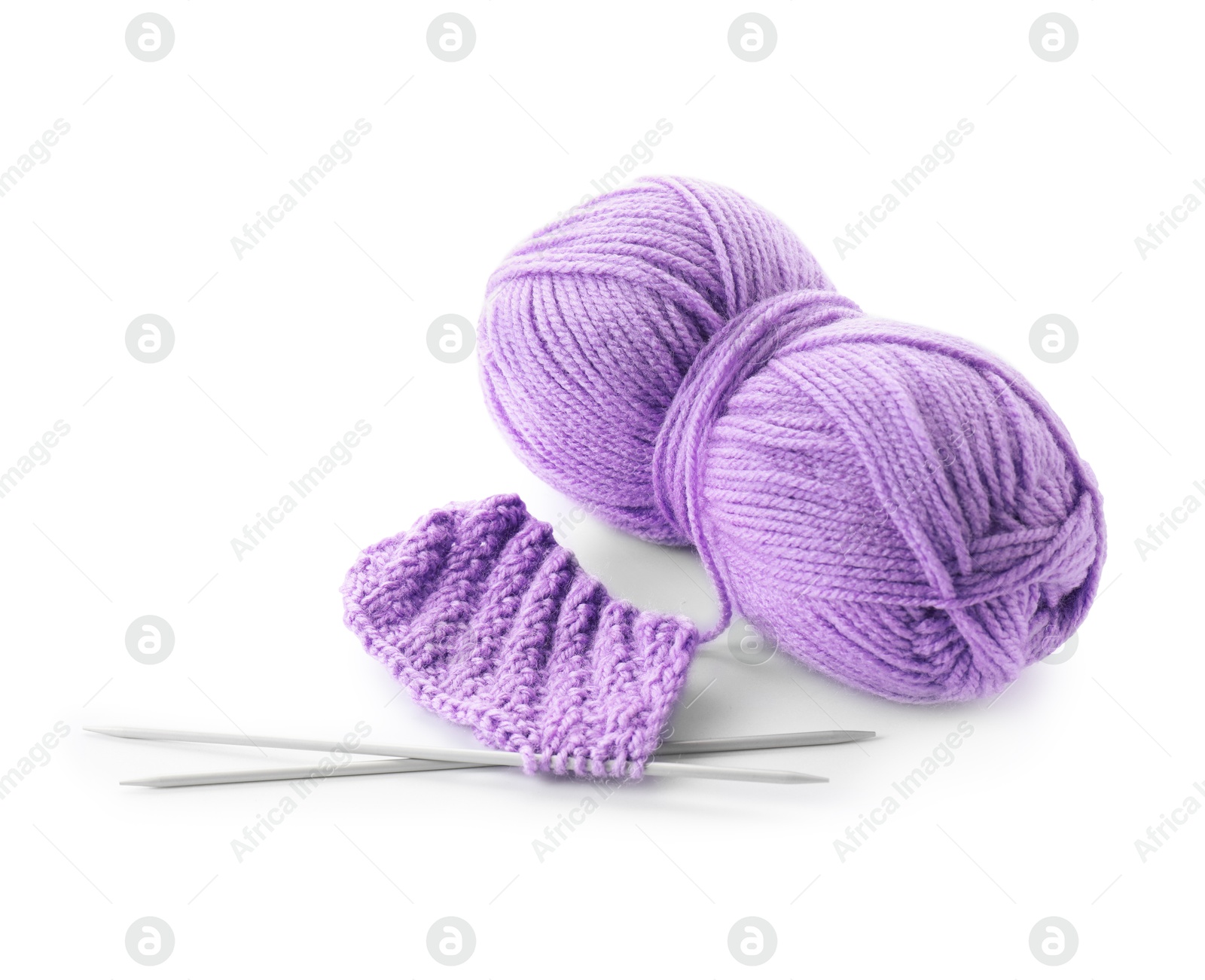 Photo of Skein of violet yarn, knitted fabric and needles isolated on white