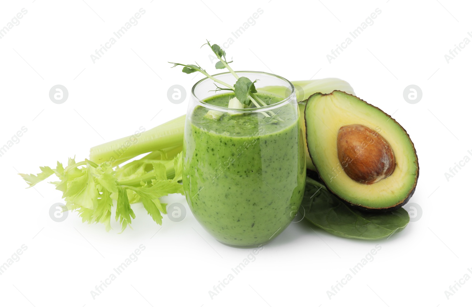 Photo of Tasty green smoothie in glass , avocado and celery isolated on white