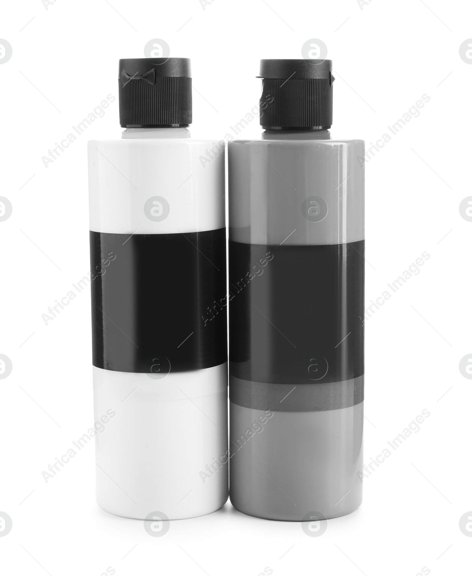 Photo of Acrylic paints of different colors in bottles isolated on white