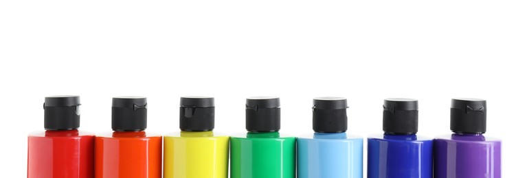 Photo of Acrylic paints of different colors in bottles isolated on white