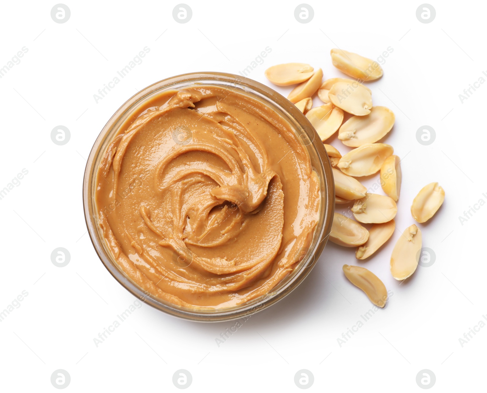 Photo of Tasty peanut butter in bowl and groundnuts isolated on white, top view