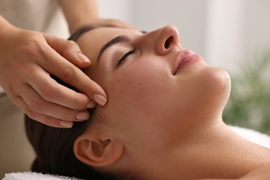 Photo of Attractive woman enjoying face massage, closeup. Beauty procedure