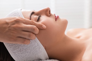 Attractive woman enjoying face massage, closeup. Beauty procedure