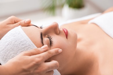 Photo of Attractive woman enjoying face massage, closeup. Beauty procedure