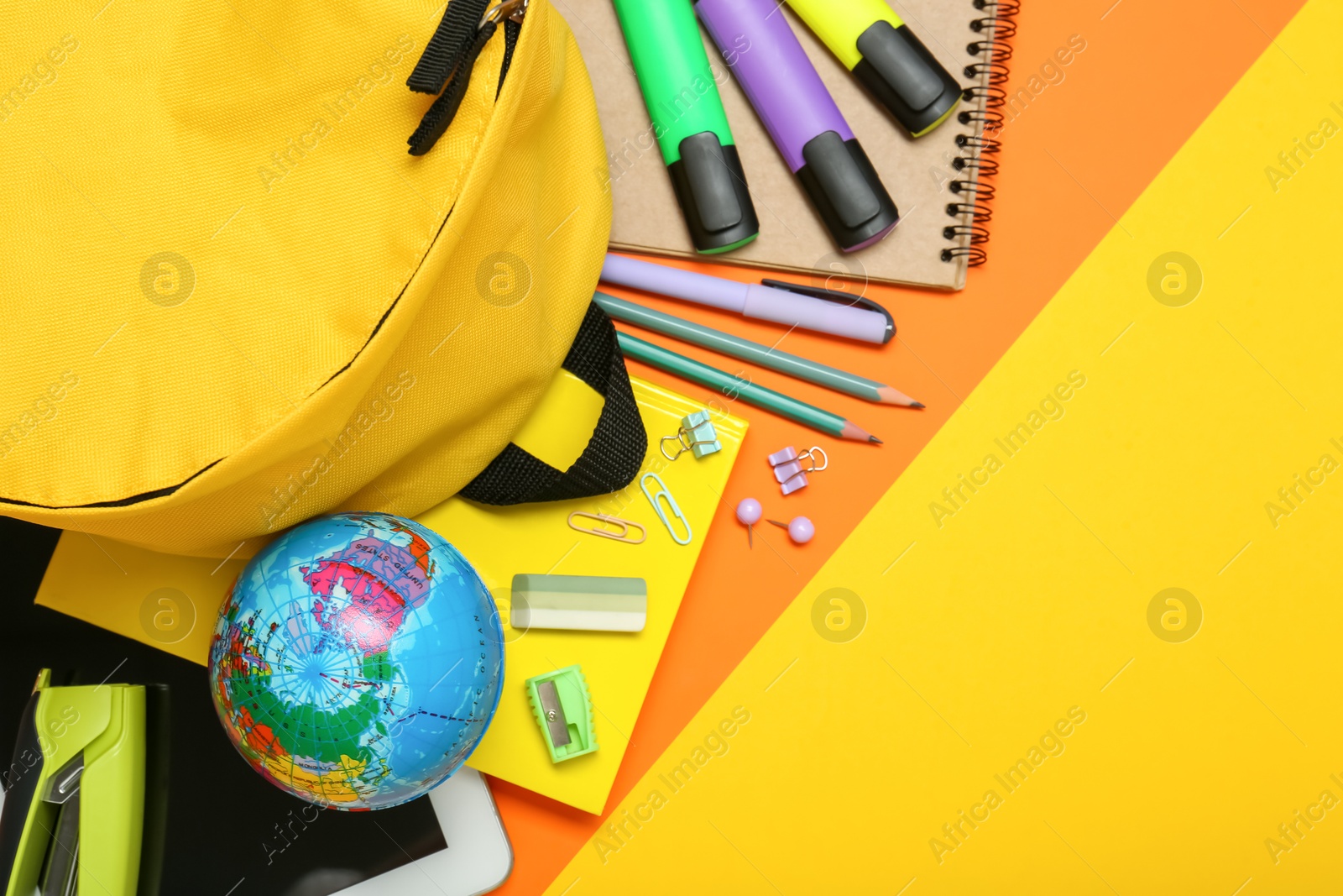 Photo of School backpack and stationery on color background, flat lay. Space for text