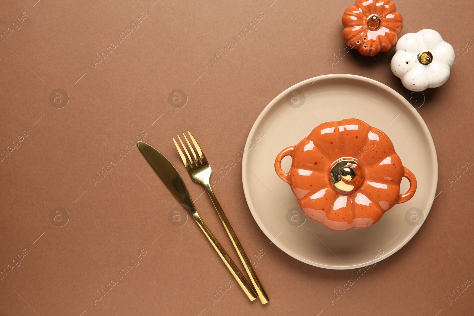 Photo of Beautiful table setting with autumn decor on brown background, flat lay. Space for text