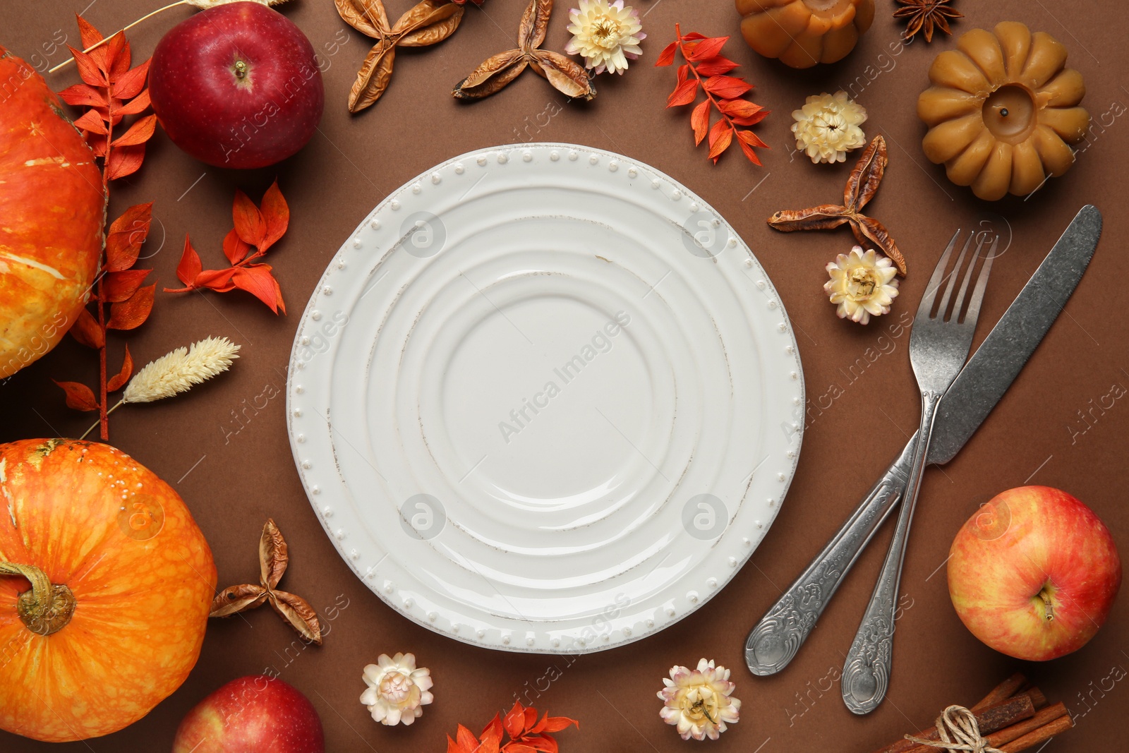 Photo of Beautiful table setting with autumn decor on brown background, flat lay