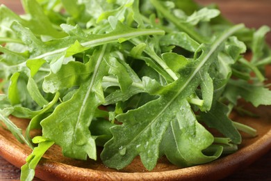 Photo of Fresh green arugula leaves on table, closeup