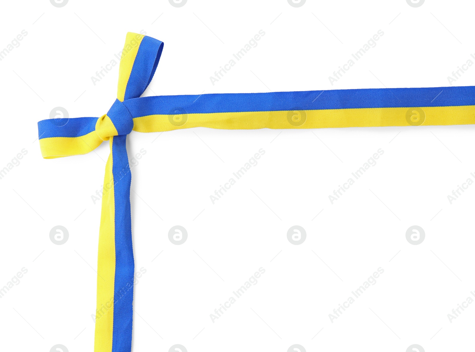 Photo of Ribbon with bow in colors of Ukrainian national flag isolated on white, top view