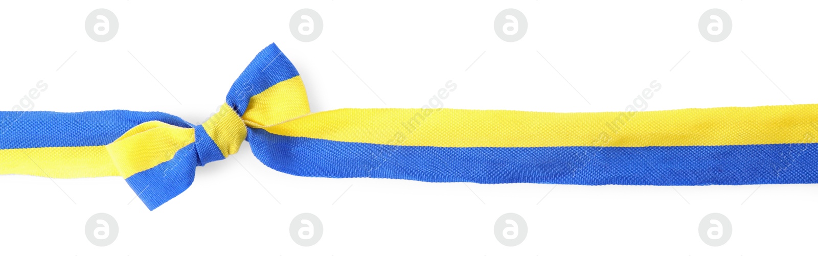 Photo of Ribbon with bow in colors of Ukrainian national flag isolated on white, top view