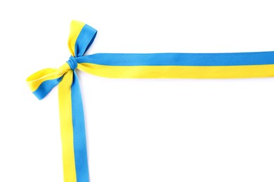 Photo of Ribbon with bow in colors of Ukrainian national flag isolated on white, top view