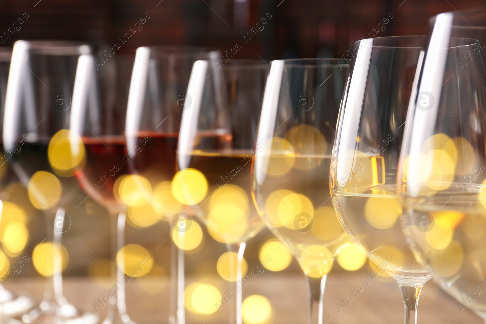 Image of Different tasty wines in glasses, closeup. Bokeh effect