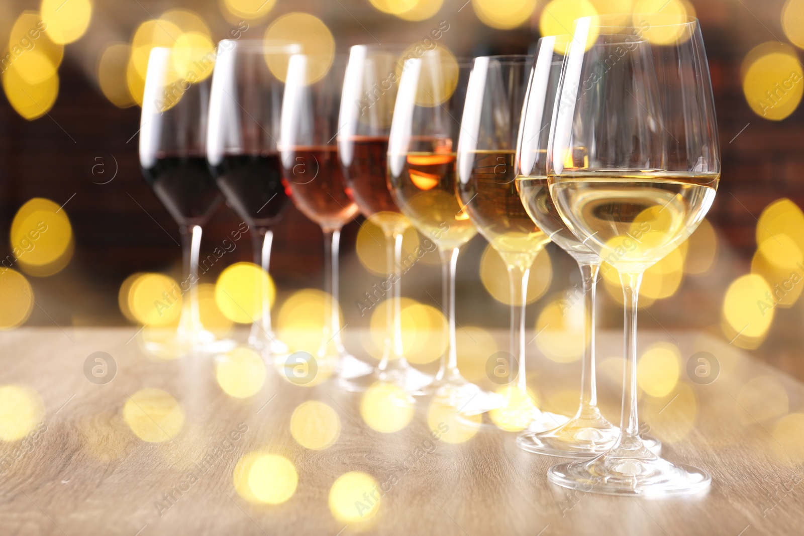 Image of Different tasty wines in glasses on table. Bokeh effect