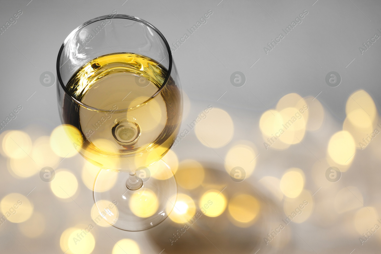 Image of Tasty wine in glass isolated on white, above view. Bokeh effect