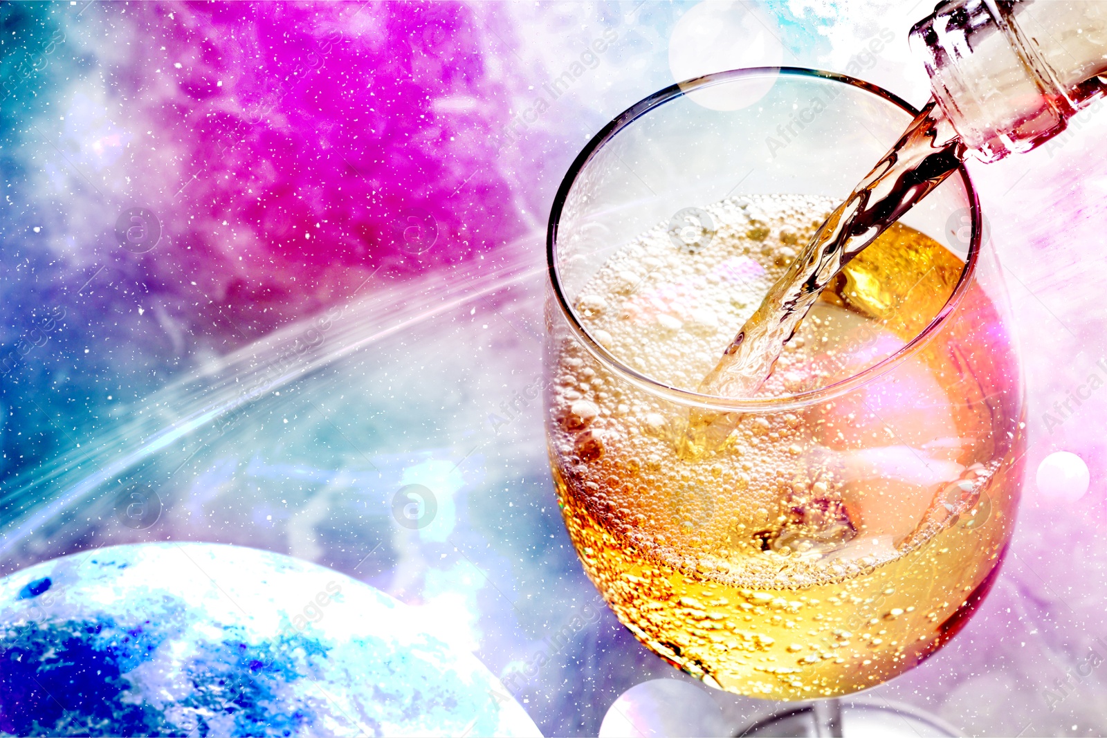 Image of Pouring white wine into glass against colorful sky, closeup. Space for text