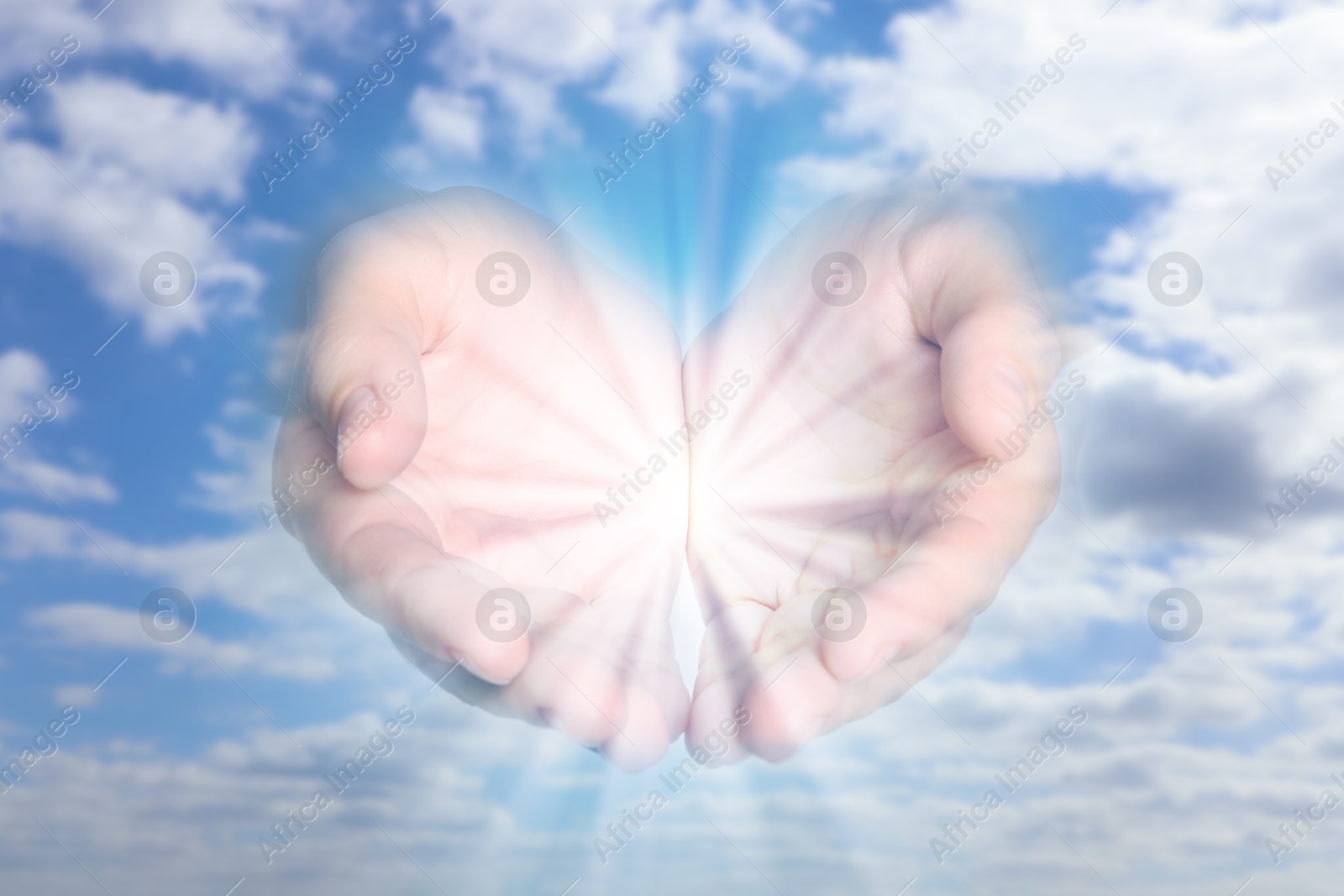 Image of Woman with holy light in hands against sky, closeup