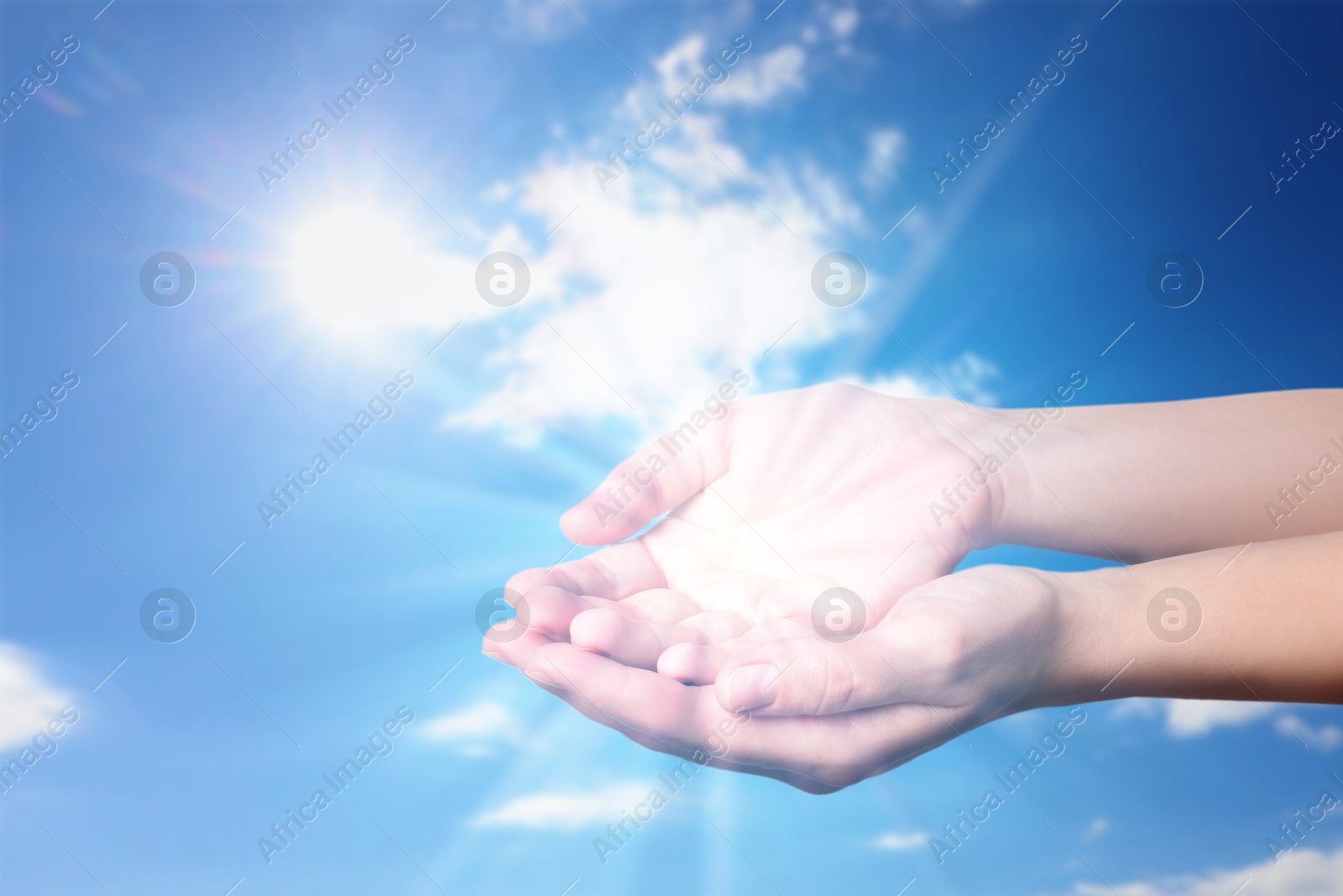 Image of Woman with holy light in hands against sky, closeup