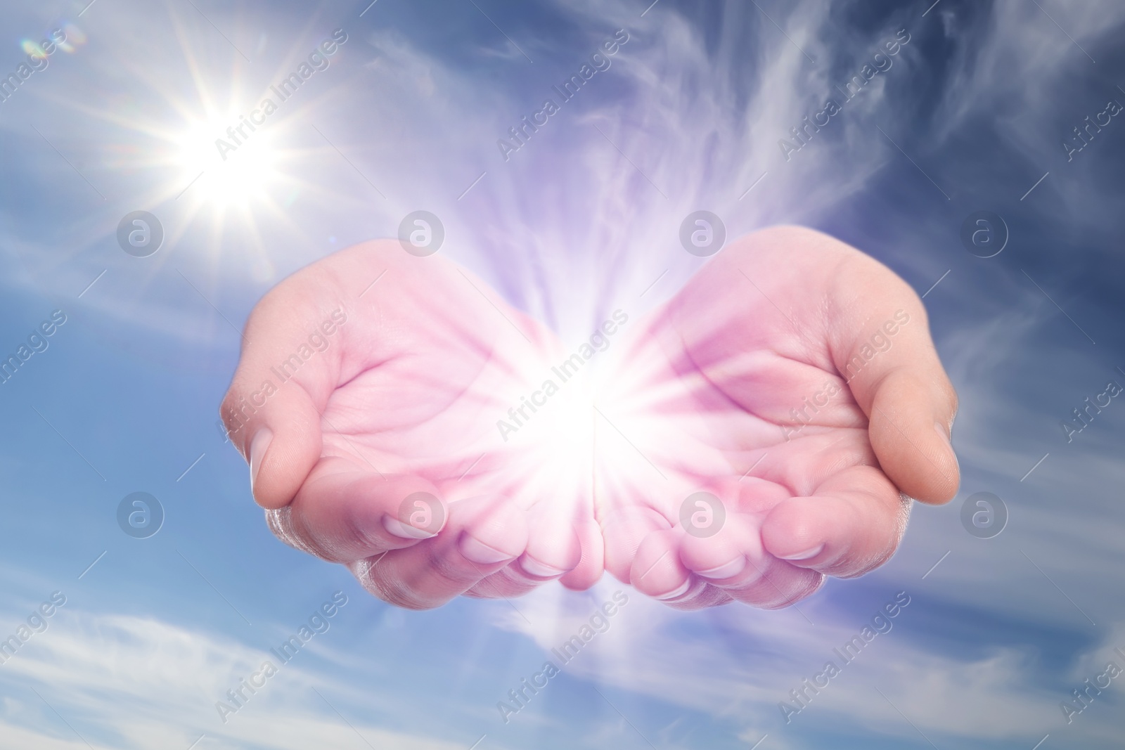 Image of Man with holy light in hands against sky, closeup