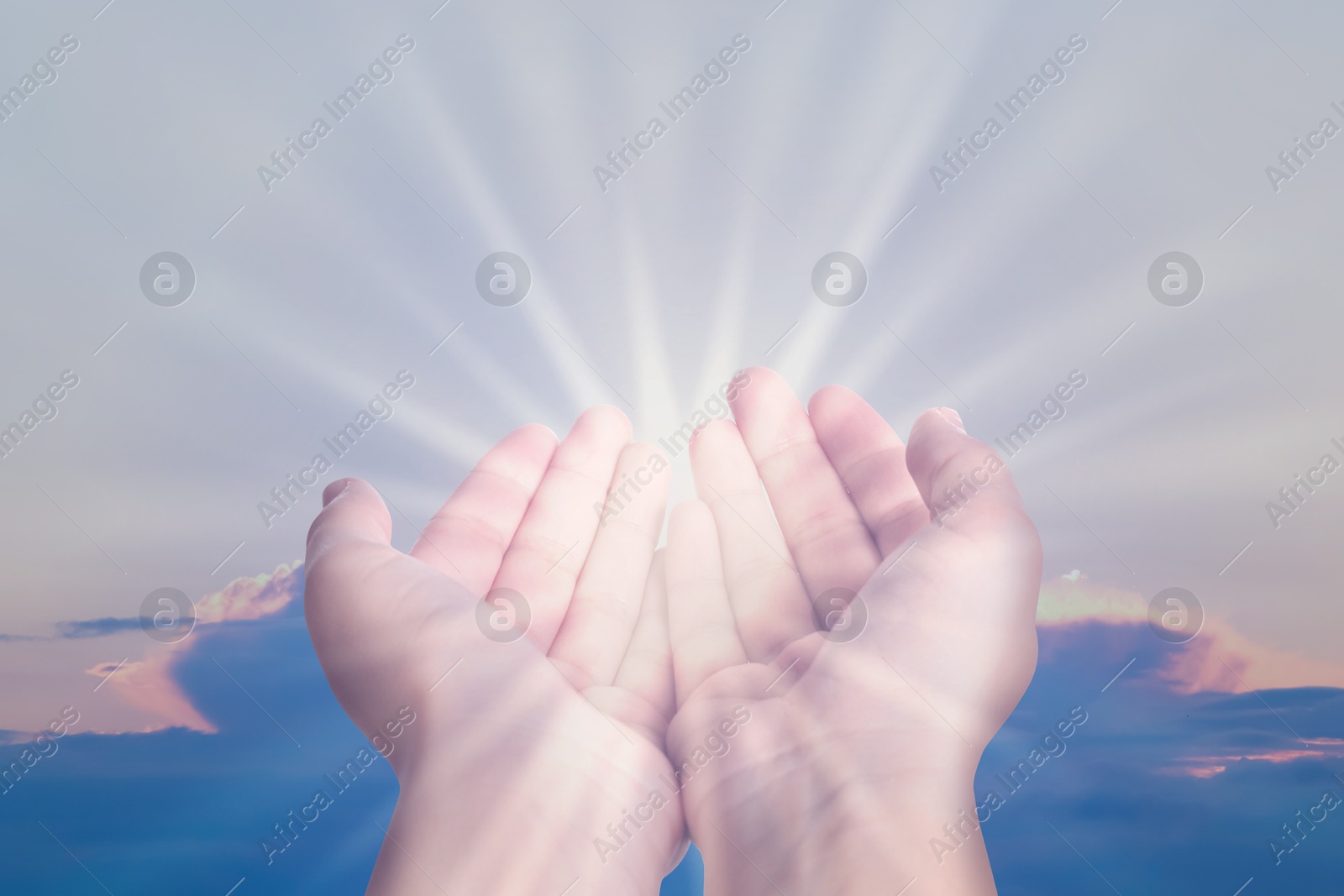 Image of Woman with holy light in hands against sky on sunrise, closeup