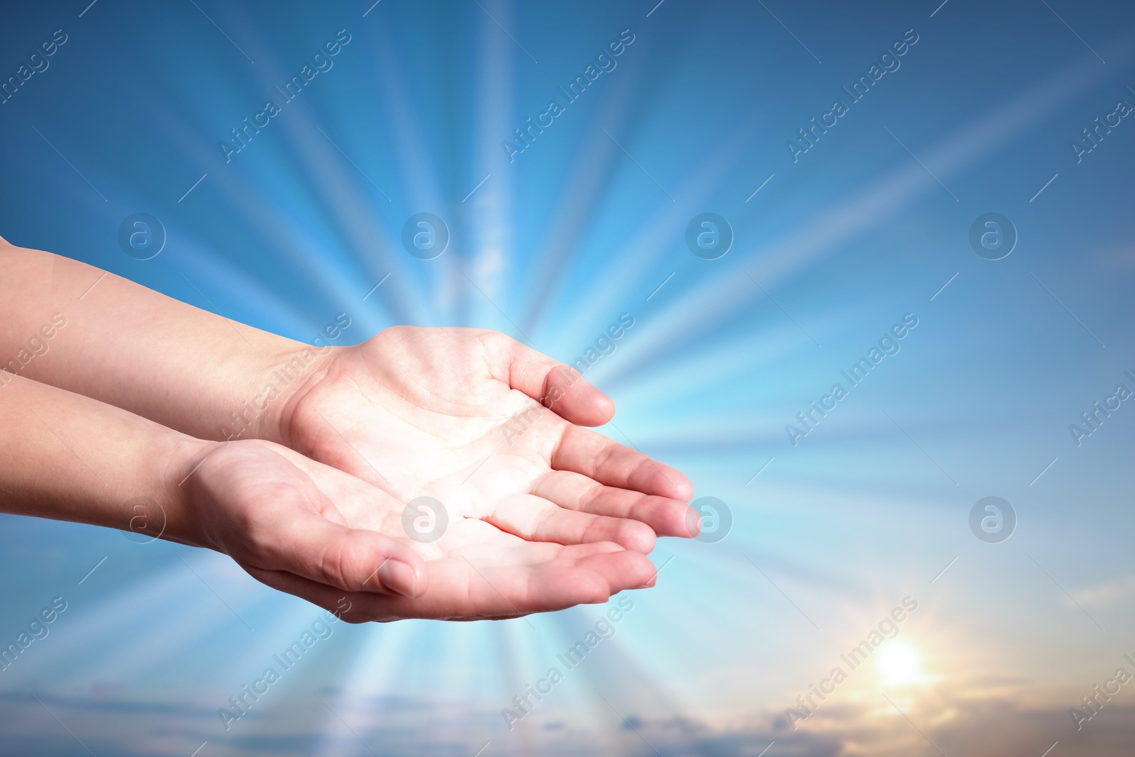 Image of Woman with holy light in hands against sky on sunrise, closeup