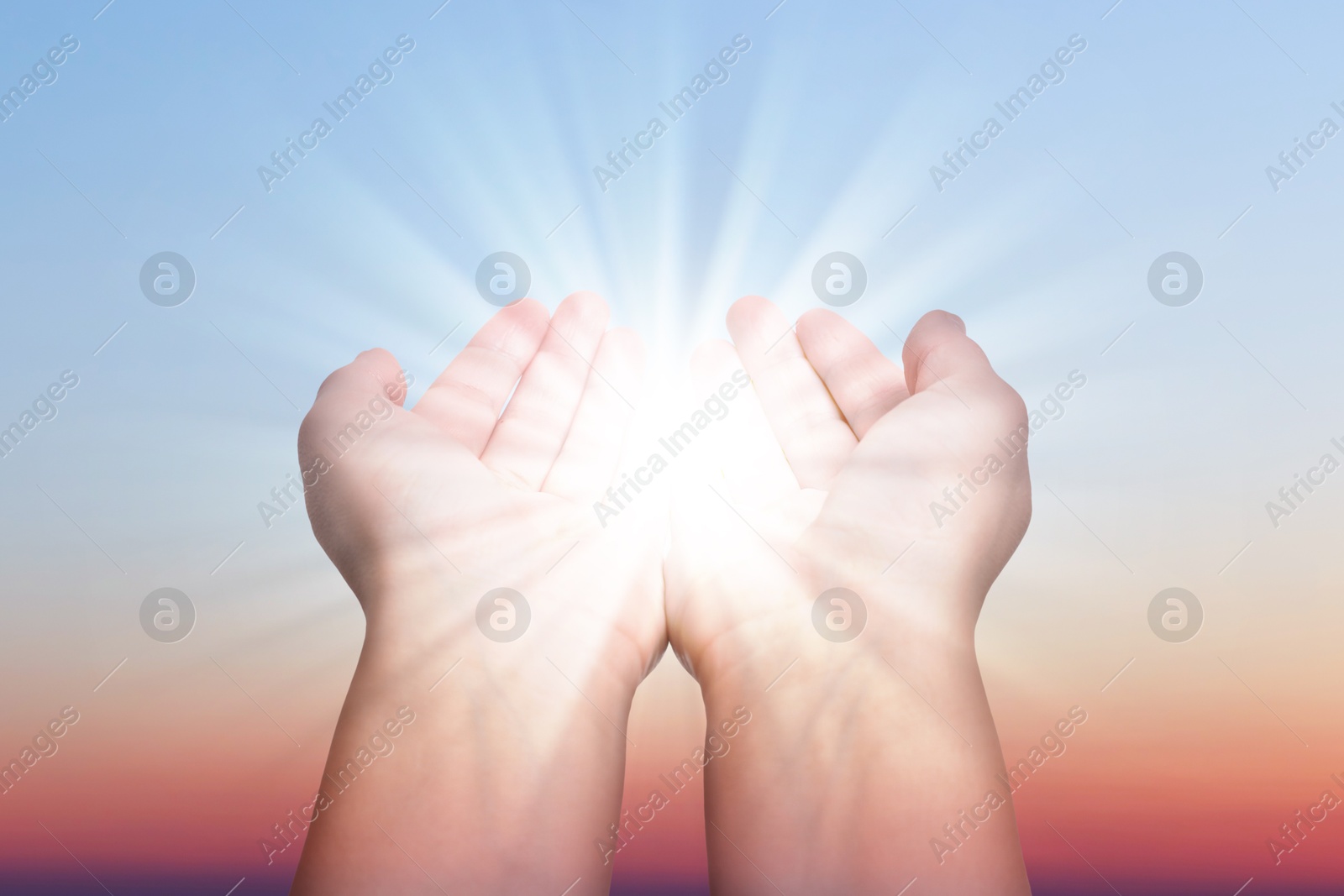 Image of Woman with holy light in hands against sky on sunrise, closeup