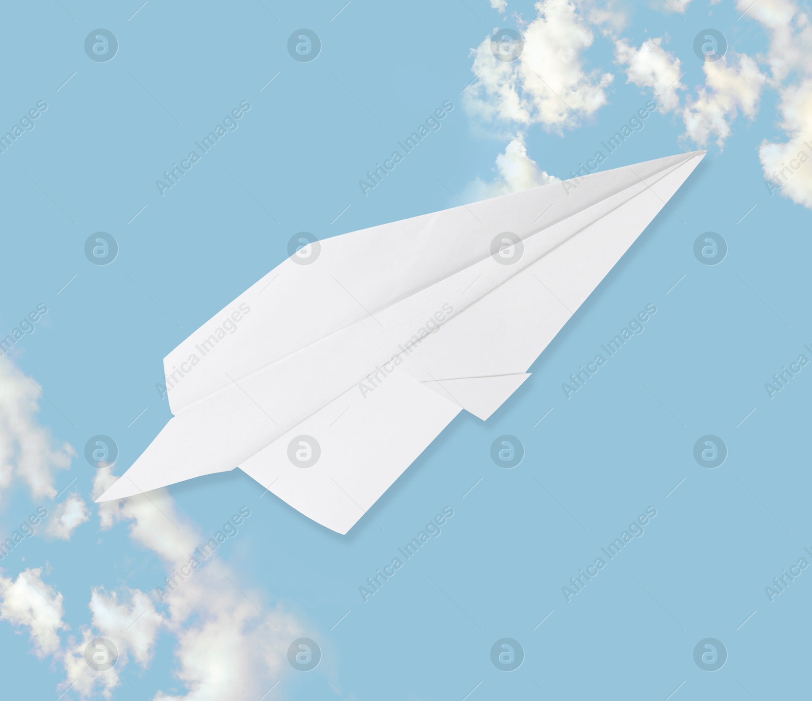 Image of Paper plane on light blue background with clouds. Time to travel