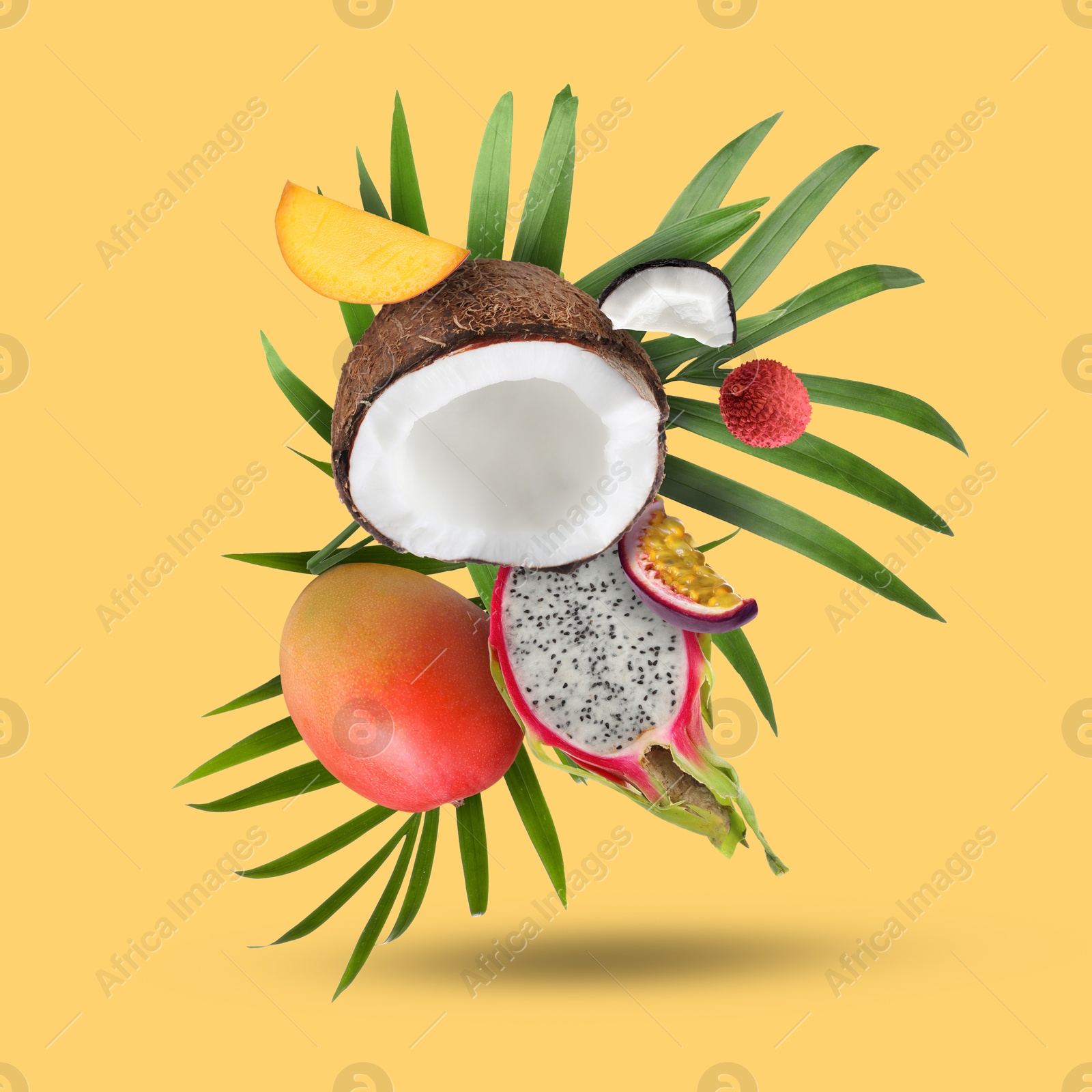 Image of Coconut, dragonfruit, mango, lychee and maracuja falling on golden background. Tropical fruits