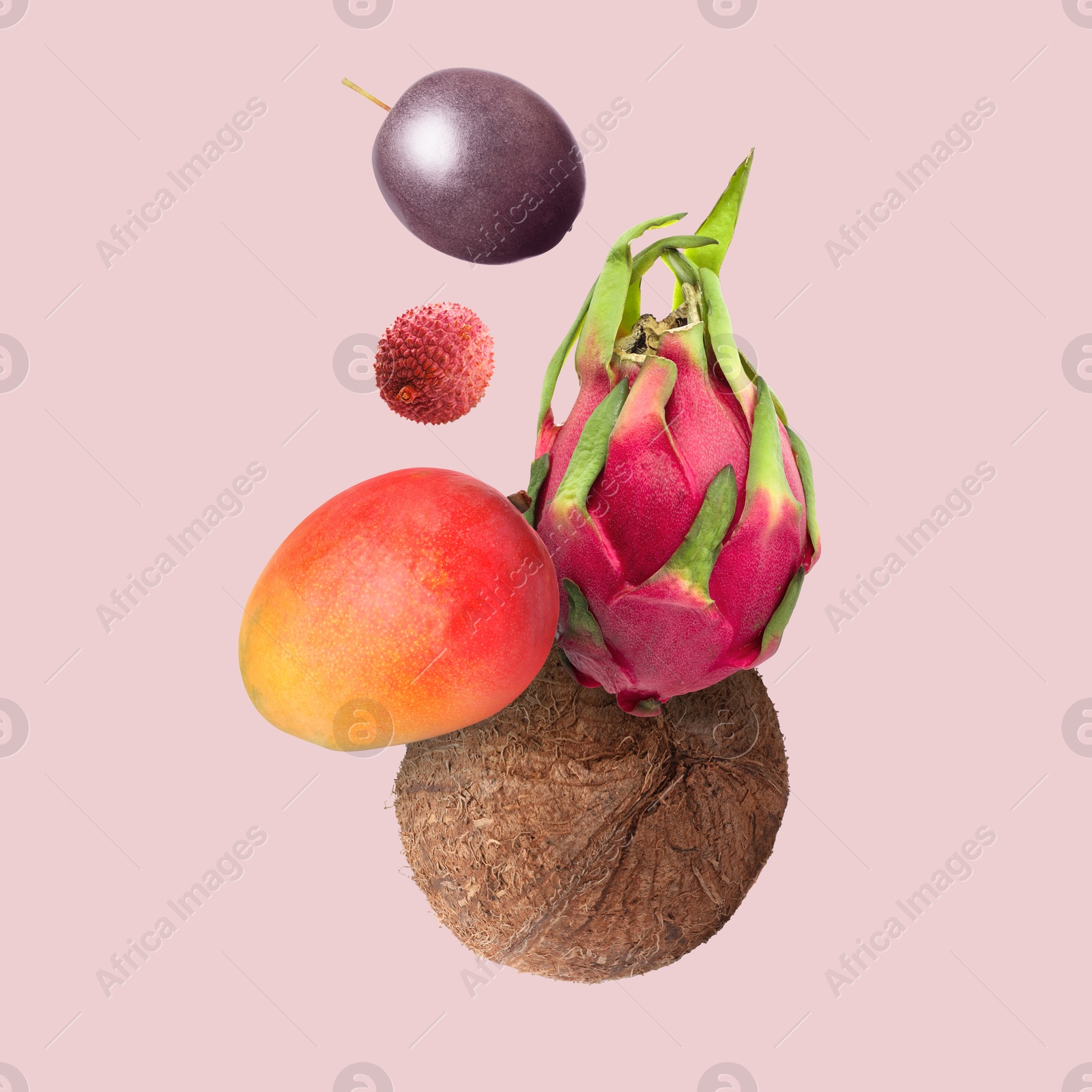 Image of Coconut, dragonfruit, mango, lychee and maracuja in air on pink background. Tropical fruits