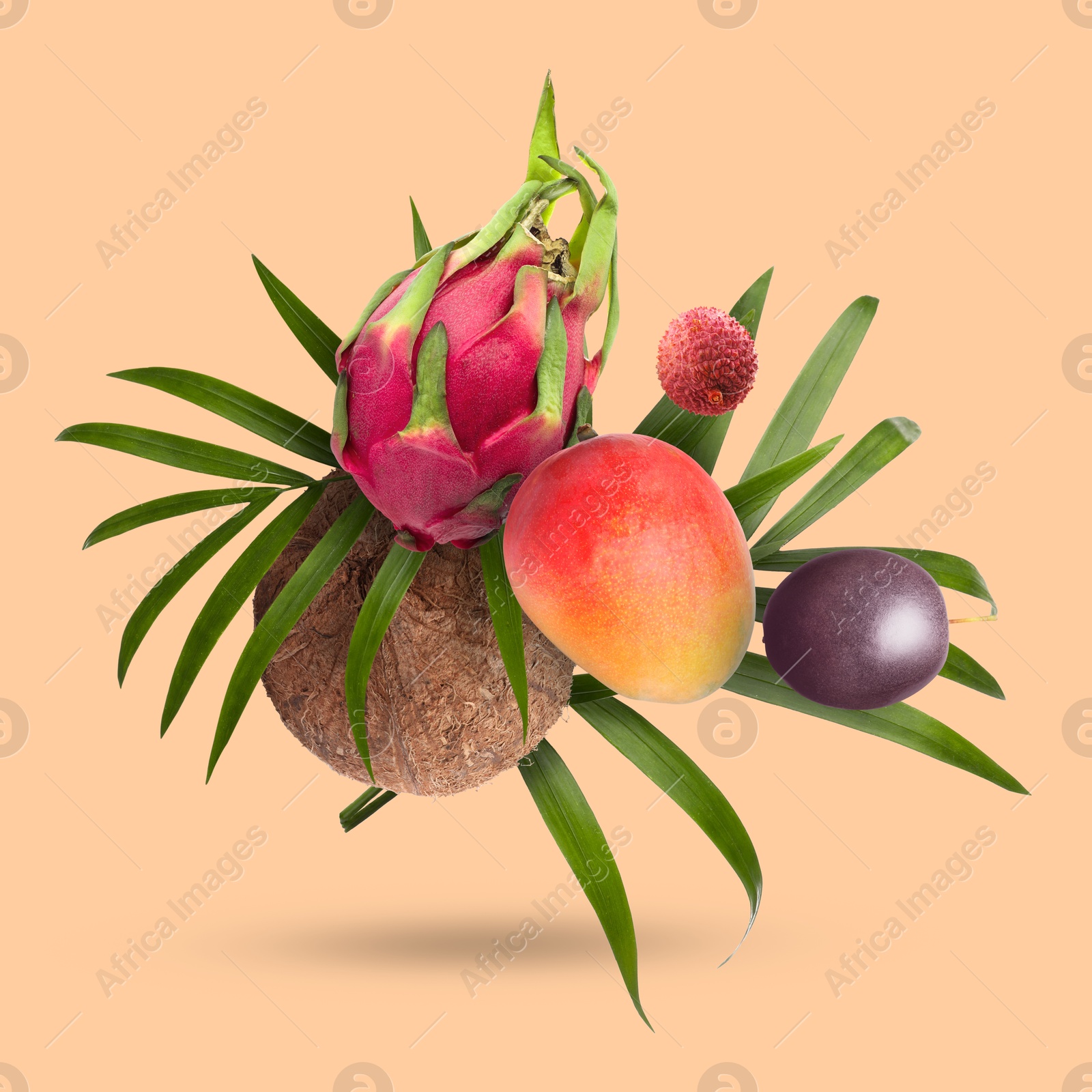 Image of Coconut, dragonfruit, mango, lychee and maracuja falling on dark beige background. Tropical fruits