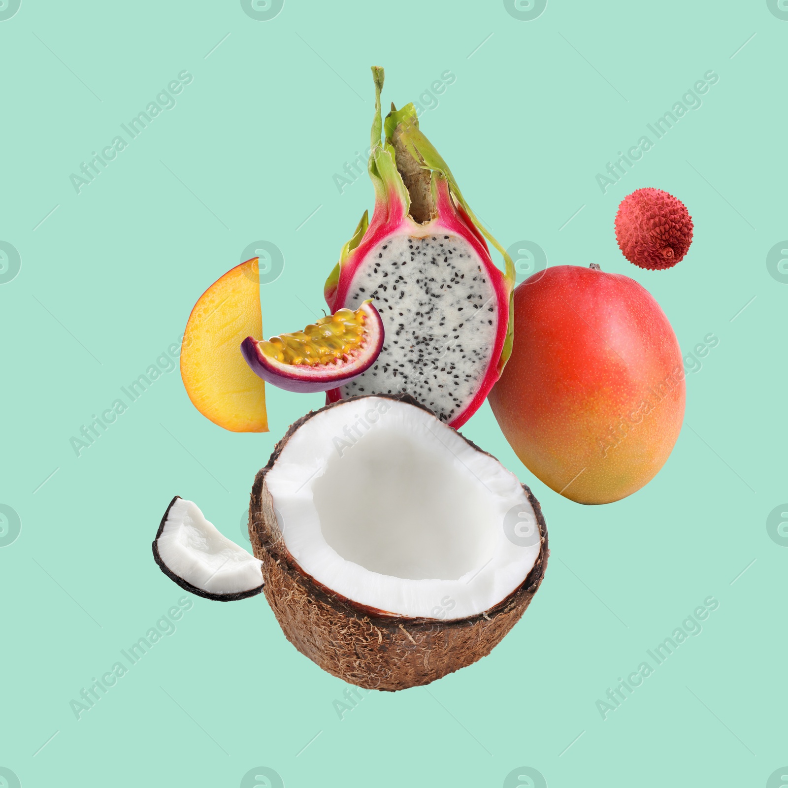 Image of Coconut, dragonfruit, mango, lychee and maracuja in air on turquoise background. Tropical fruits