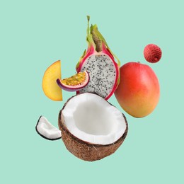 Image of Coconut, dragonfruit, mango, lychee and maracuja in air on turquoise background. Tropical fruits