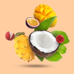 Image of Coconut, dragonfruit, mango, lychees and maracuja falling on dark beige background. Tropical fruits