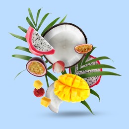 Image of Coconut, dragonfruit, mango, lychees and maracuja in air on light blue background. Tropical fruits