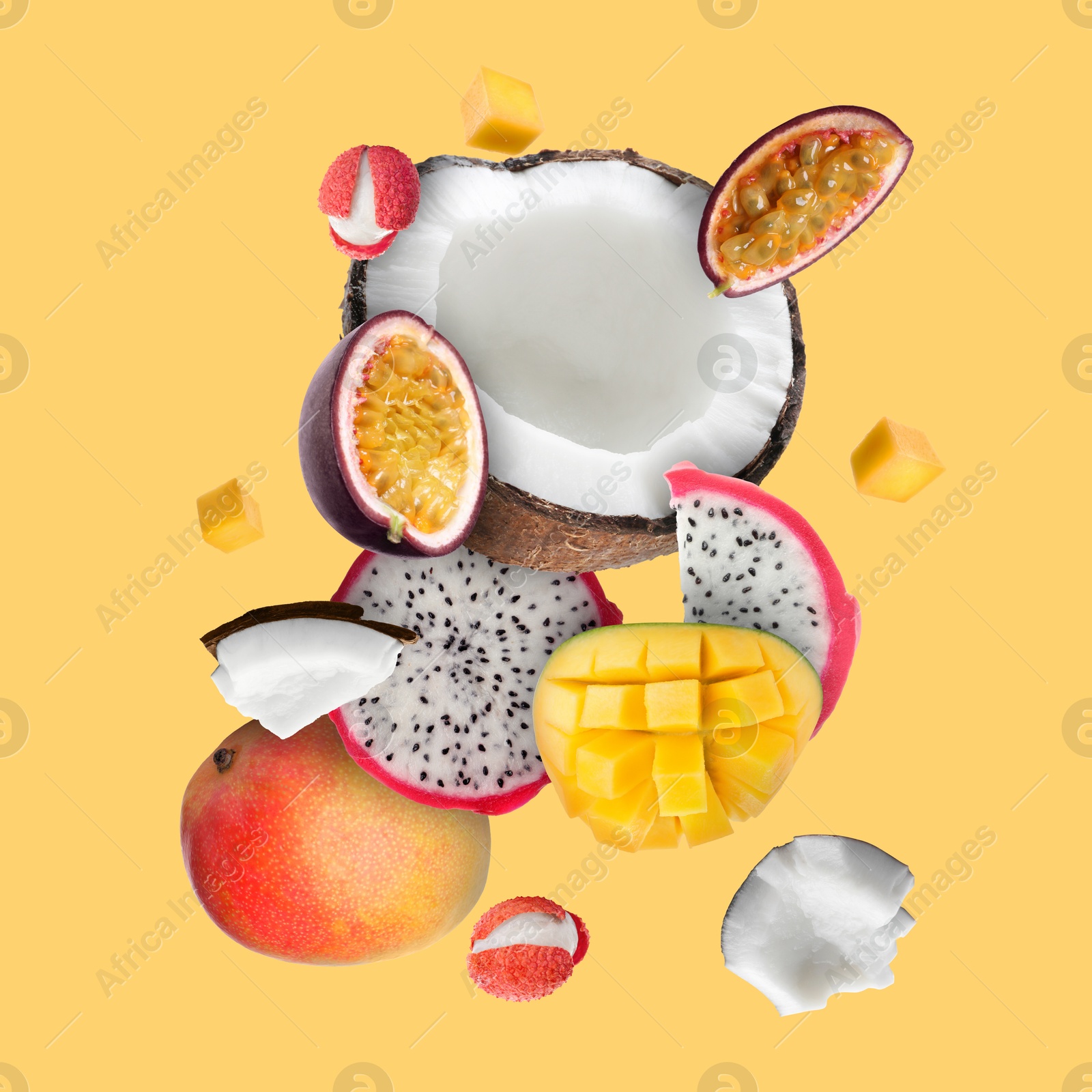 Image of Coconut, dragonfruit, mango, lychees and maracuja in air on golden background. Tropical fruits