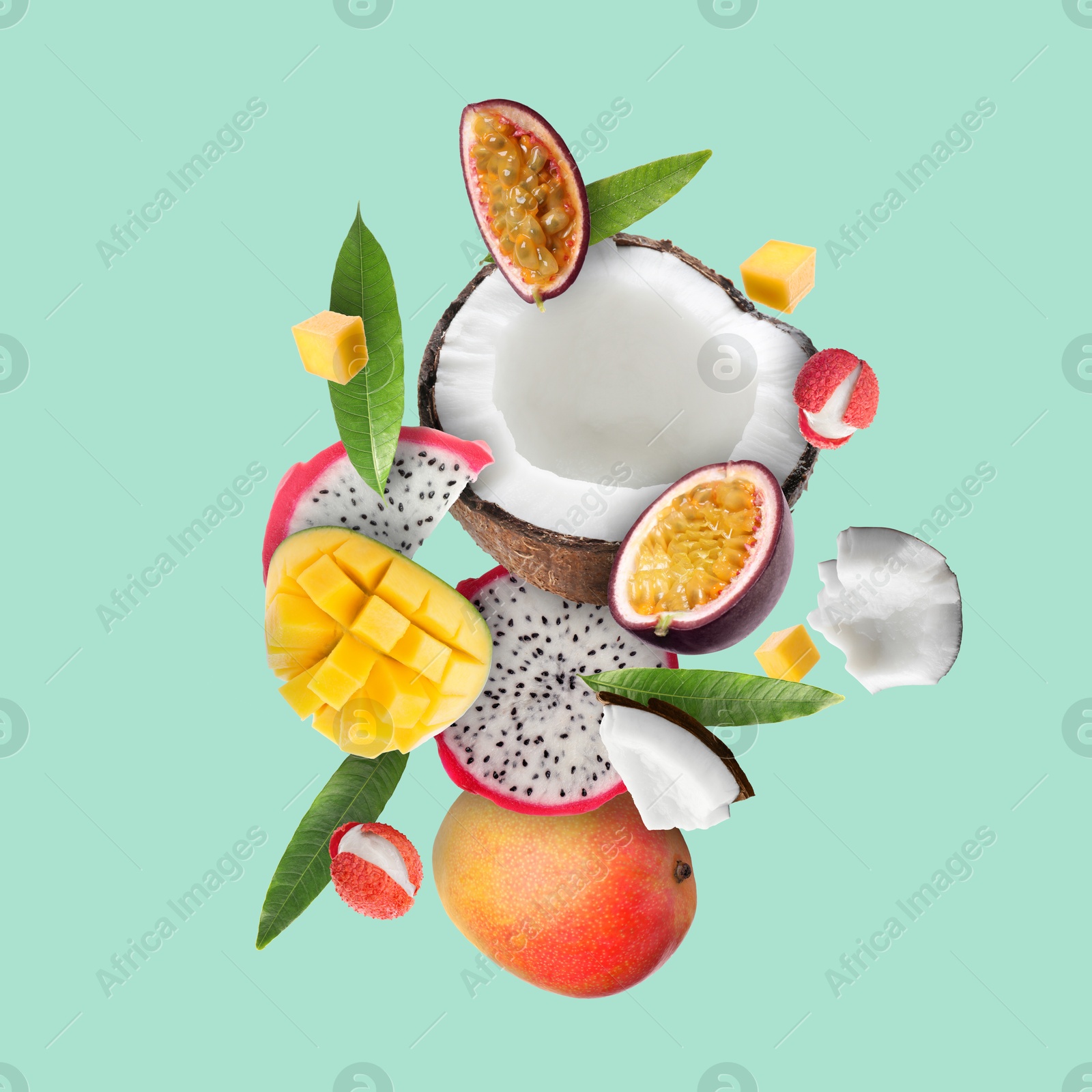 Image of Coconut, dragonfruit, mango, lychees and maracuja in air on turquoise background. Tropical fruits