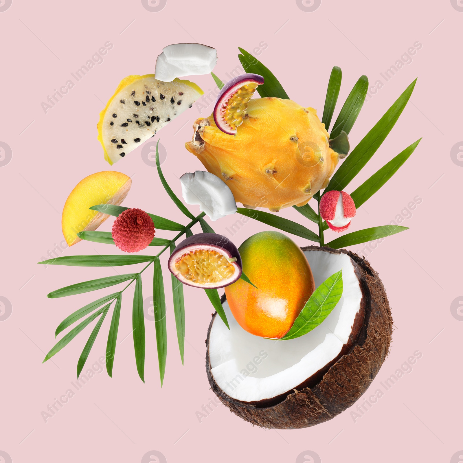 Image of Coconut, dragonfruit, mango, lychees and maracuja in air on pink background. Tropical fruits